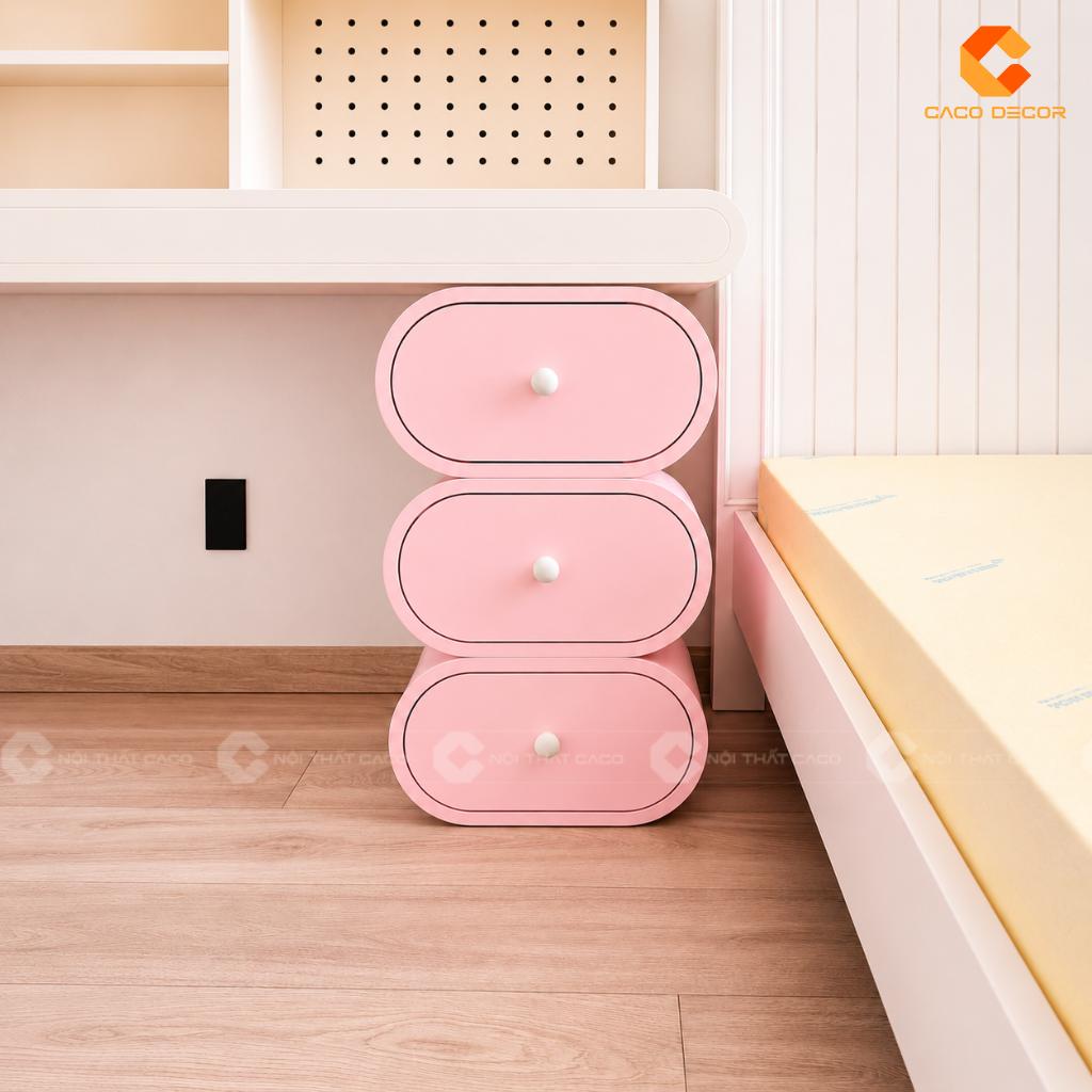 Hộc tủ bàn học trẻ em màu hồng pastel đặt cạnh giường ngủ