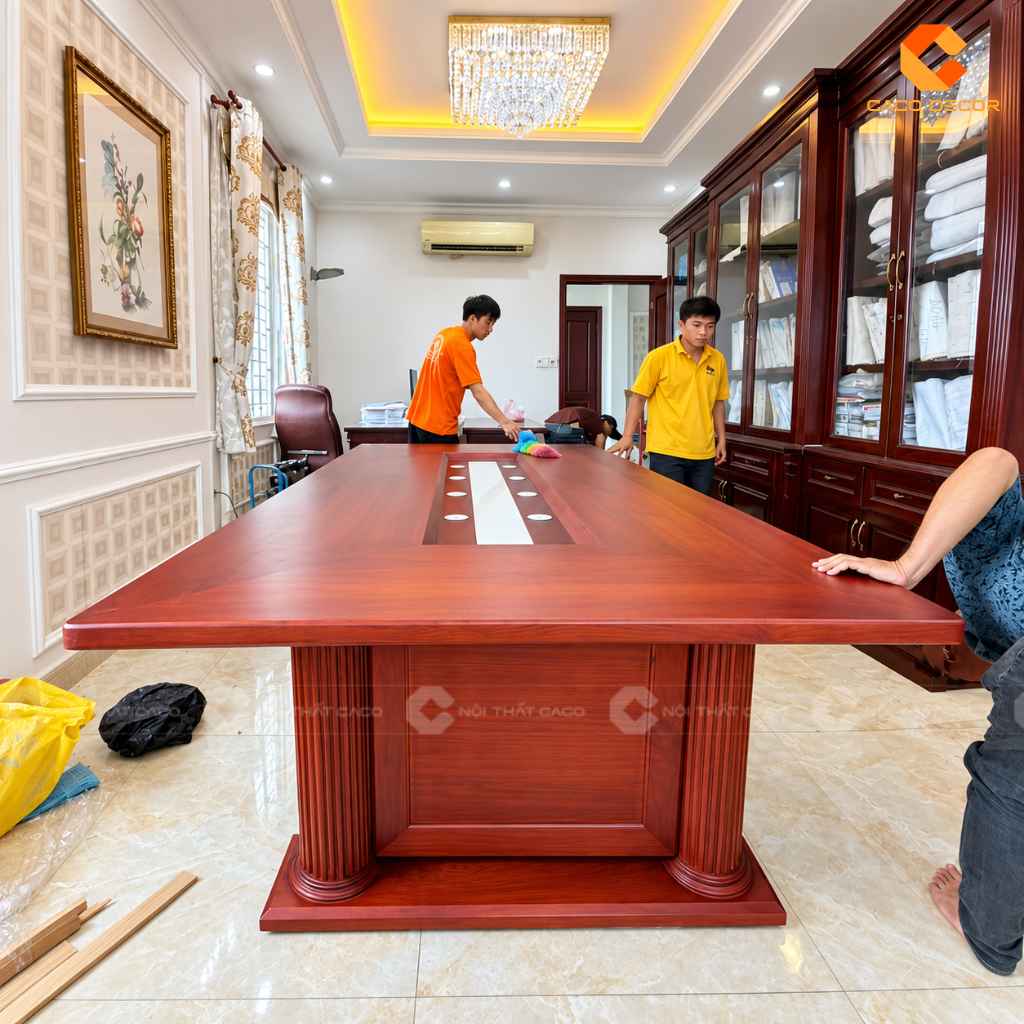 Bàn phòng họp gỗ gõ đỏ của anh Thạch đang được vệ sinh sau khi lắp đặt tại xã Bình Lợi